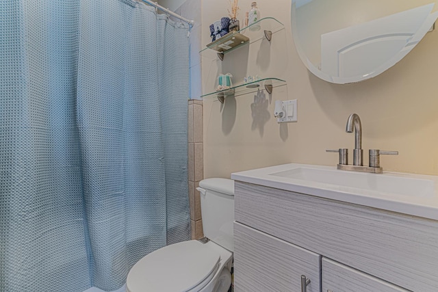 bathroom with toilet, vanity, and a shower with curtain