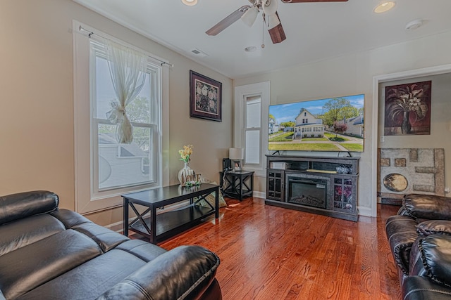 living area with a ceiling fan, wood finished floors, recessed lighting, and baseboards