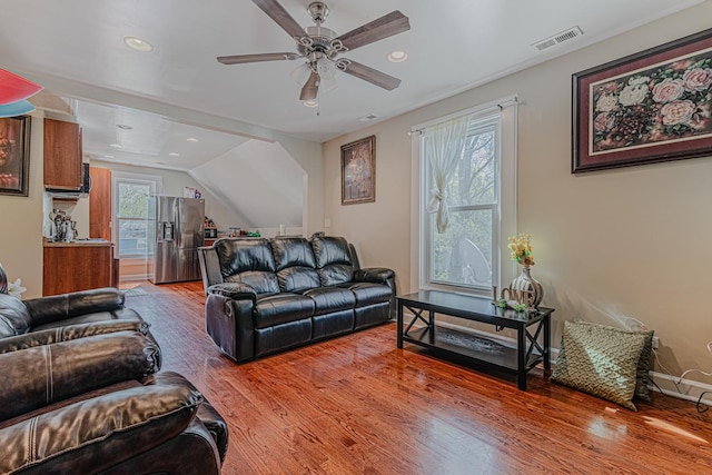 living area with light wood-style floors, a ceiling fan, recessed lighting, and lofted ceiling