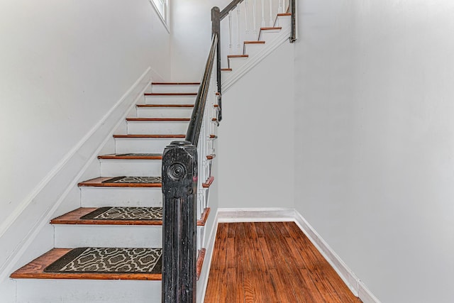 stairway featuring wood finished floors
