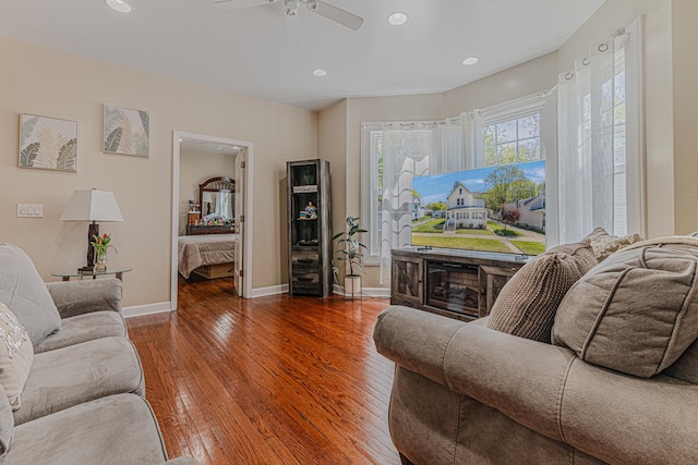 living area with a ceiling fan, hardwood / wood-style flooring, baseboards, and recessed lighting