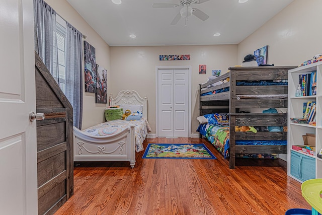 bedroom featuring wood finished floors, recessed lighting, a ceiling fan, and baseboards