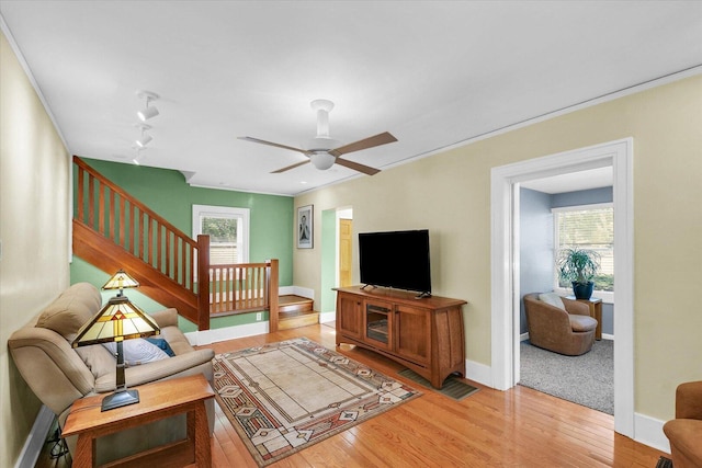 606 S Cedar St, Urbana, IL 61801 - living room with wood finished floors, stairs, baseboards, a ceiling fan, and ornamental molding