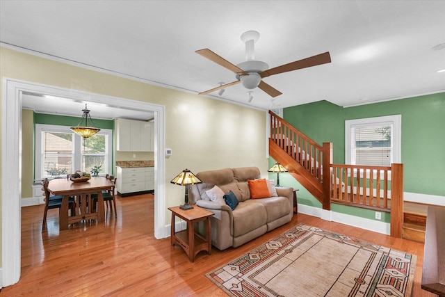 606 S Cedar St, Urbana, IL 61801 - living room with wood finished floors, a ceiling fan, stairs, and plenty of natural light
