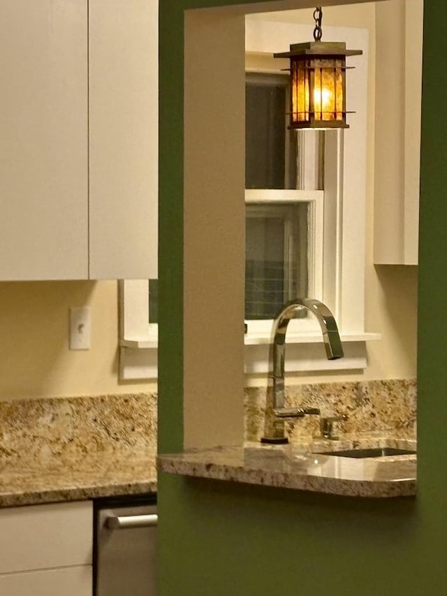 606 S Cedar St, Urbana, IL 61801 - kitchen featuring white cabinets and light stone counters