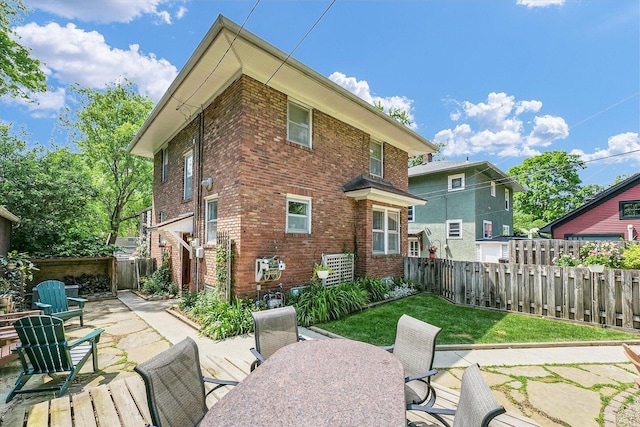 606 S Cedar St, Urbana, IL 61801 - rear view of house featuring brick siding, a patio, and outdoor dining space