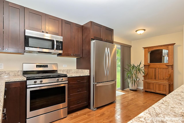 2505 S Harriet Ln, Holiday Hills, IL 60051 - kitchen featuring appliances with stainless steel finishes, light wood-type flooring, and dark brown cabinets
