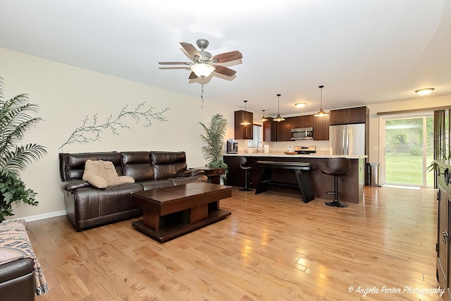 2505 S Harriet Ln, Holiday Hills, IL 60051 - living room with light wood finished floors, ceiling fan, and baseboards