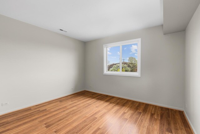 empty room with light wood-style floors and baseboards