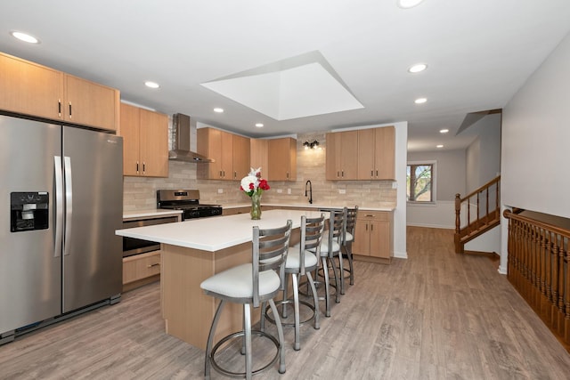 12123 S 72nd Ct, Palos Heights, IL 60463 - kitchen featuring stainless steel appliances, wall chimney exhaust hood, light countertops, light wood-style flooring, and recessed lighting