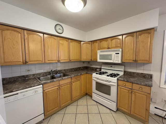 4456 W Gunnison St Unit 2A, Chicago, IL 60630 - kitchen with white appliances, a sink, dark countertops, and light tile patterned floors