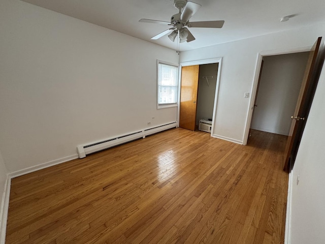 4456 W Gunnison St Unit 2A, Chicago, IL 60630 - unfurnished bedroom with a baseboard radiator, light wood finished floors, a closet, a ceiling fan, and baseboards