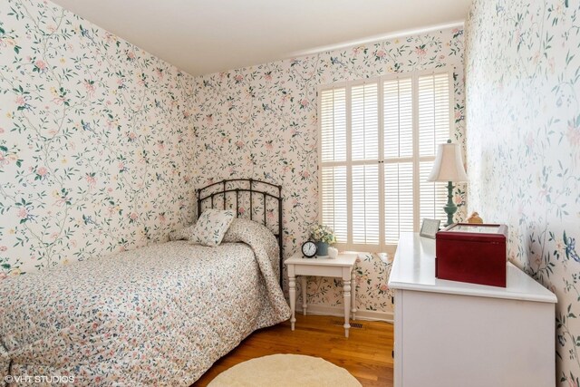 14642 S Pebble Creek Dr, Homer Glen, IL 60491 - bedroom with wallpapered walls, wood finished floors, multiple windows, and baseboards