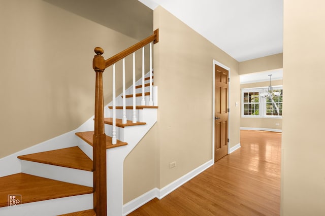 1532 Chat Ct, Naperville, IL 60565 - staircase with a chandelier, wood finished floors, and baseboards