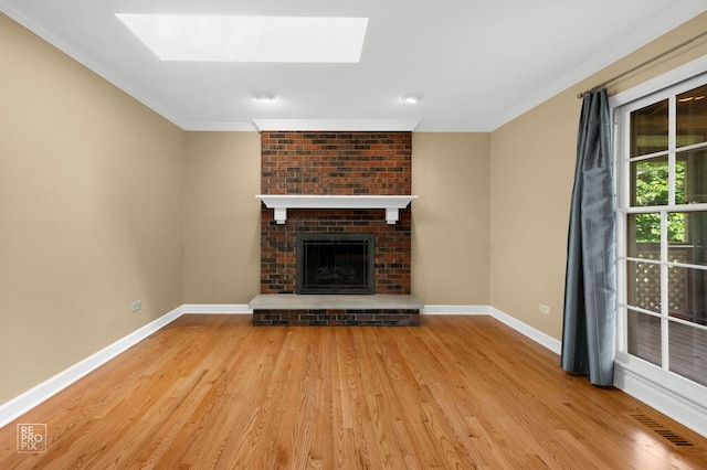 1532 Chat Ct, Naperville, IL 60565 - unfurnished living room with baseboards, wood finished floors, crown molding, a skylight, and a brick fireplace