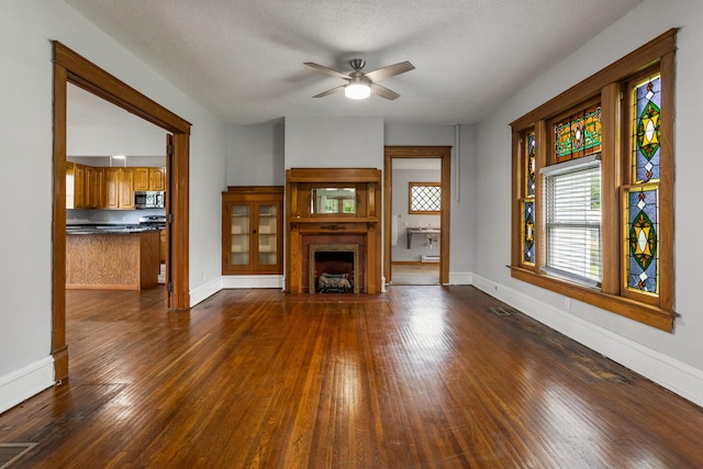 201 E Court St, Paris, IL 61944 - unfurnished living room with a ceiling fan, dark wood-style flooring, and baseboards