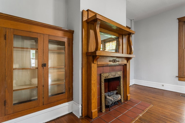 201 E Court St, Paris, IL 61944 - detailed view of wood finished floors, a fireplace, and baseboards