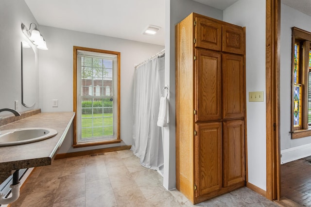 201 E Court St, Paris, IL 61944 - full bath with a sink, baseboards, and curtained shower