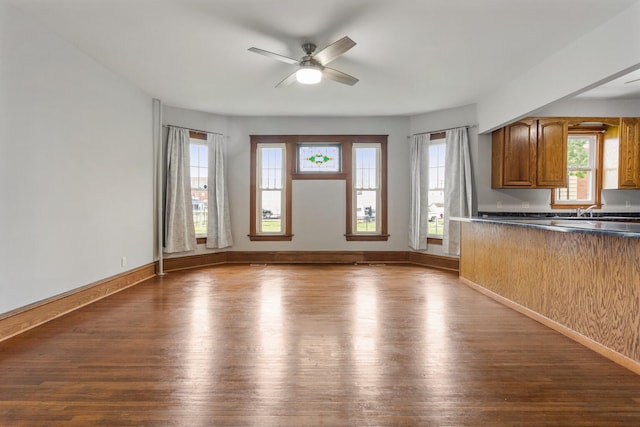 201 E Court St, Paris, IL 61944 - kitchen with dark countertops, dark wood-type flooring, healthy amount of natural light, and brown cabinets
