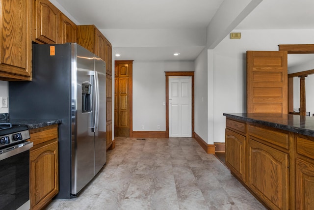 201 E Court St, Paris, IL 61944 - kitchen featuring stainless steel appliances, brown cabinets, recessed lighting, baseboards, and dark stone countertops