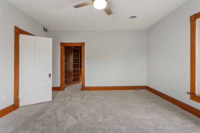 201 E Court St, Paris, IL 61944 - unfurnished bedroom with carpet floors, baseboards, and a ceiling fan