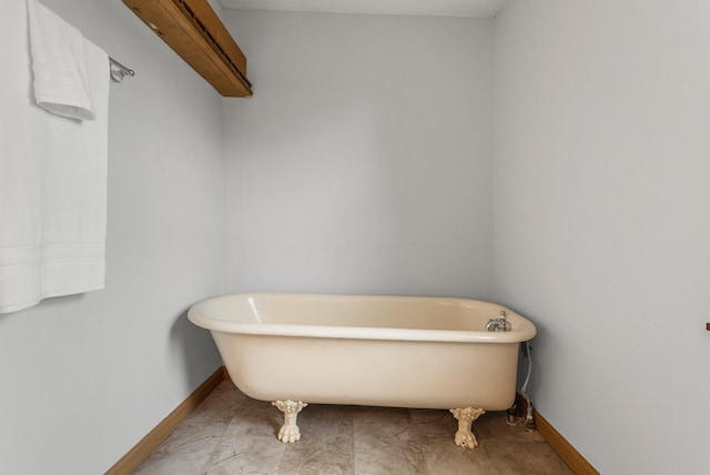 201 E Court St, Paris, IL 61944 - bathroom with a freestanding bath and baseboards