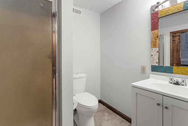201 E Court St, Paris, IL 61944 - bathroom with toilet, vanity, a stall shower, tile patterned flooring, and baseboards