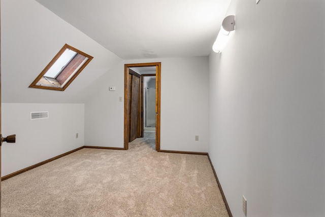 201 E Court St, Paris, IL 61944 - additional living space featuring a skylight, light colored carpet, vaulted ceiling, and baseboards