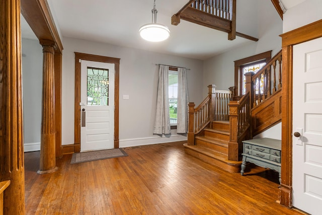 201 E Court St, Paris, IL 61944 - entryway with ornate columns, wood finished floors, baseboards, and stairway