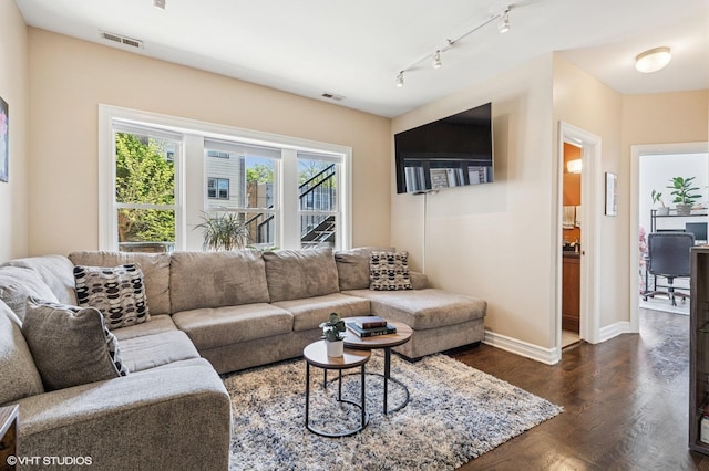 2217 W Foster Ave Unit 1, Chicago, IL 60625 - living room featuring dark wood-style floors, rail lighting, and baseboards