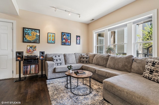 2217 W Foster Ave Unit 1, Chicago, IL 60625 - living room featuring dark wood finished floors, track lighting, and baseboards