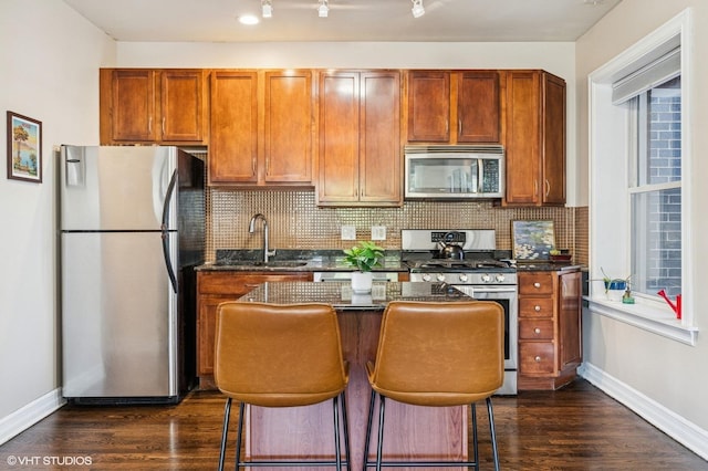 2217 W Foster Ave Unit 1, Chicago, IL 60625 - kitchen featuring appliances with stainless steel finishes, baseboards, dark wood-style floors, and a sink
