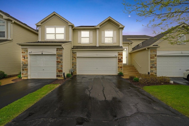 1913 Misty Ridge Ln, Aurora, IL 60503 - view of front facade with stone siding, driveway, and a garage