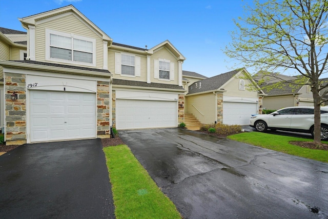 1913 Misty Ridge Ln, Aurora, IL 60503 - view of front facade featuring stone siding, driveway, and an attached garage