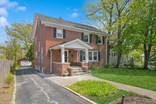 1557 Green Bay Rd, Highland Park, IL 60035 - view of front of house with brick siding, a detached garage, and an outbuilding