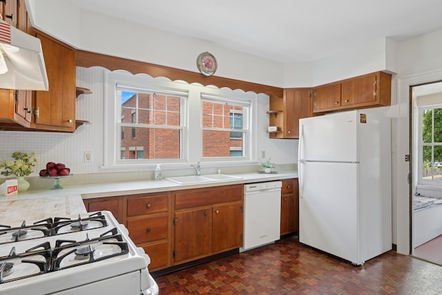 1557 Green Bay Rd, Highland Park, IL 60035 - kitchen with white appliances, a sink, brown cabinetry, under cabinet range hood, and light countertops