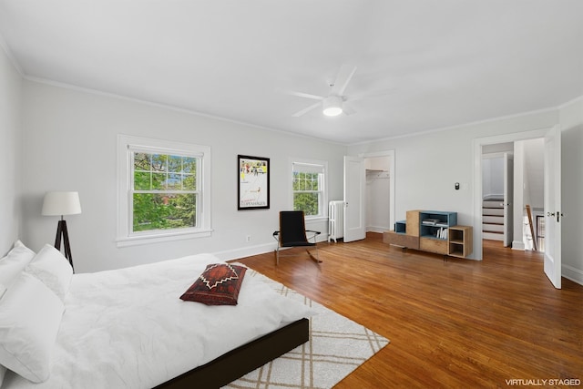1557 Green Bay Rd, Highland Park, IL 60035 - bedroom with ornamental molding, wood finished floors, baseboards, ceiling fan, and a closet