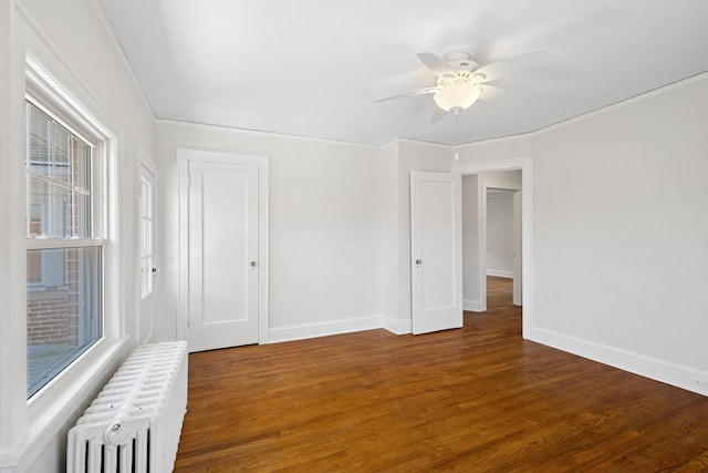 1557 Green Bay Rd, Highland Park, IL 60035 - empty room with radiator, ceiling fan, wood finished floors, baseboards, and ornamental molding