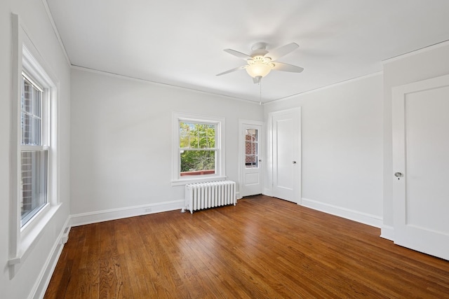 1557 Green Bay Rd, Highland Park, IL 60035 - spare room featuring radiator, a ceiling fan, wood finished floors, ornamental molding, and baseboards