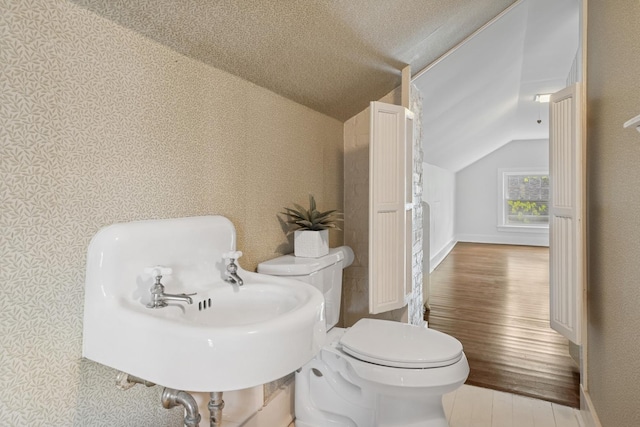 1557 Green Bay Rd, Highland Park, IL 60035 - half bathroom featuring lofted ceiling, wood finished floors, toilet, a sink, and baseboards