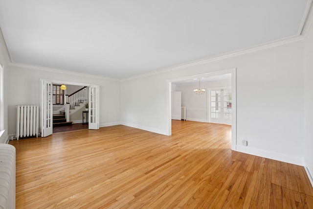1557 Green Bay Rd, Highland Park, IL 60035 - unfurnished living room with radiator, a chandelier, stairs, crown molding, and light wood finished floors