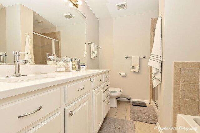 390 W Mahogany Ct Unit 301, Palatine, IL 60067 - full bathroom featuring tile patterned flooring, toilet, a stall shower, vanity, and a tub to relax in