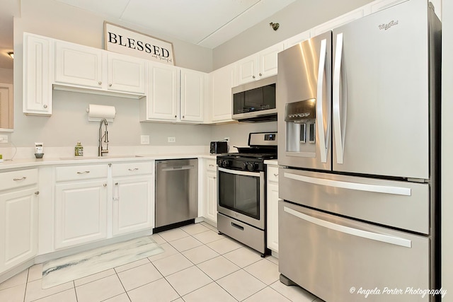 390 W Mahogany Ct Unit 301, Palatine, IL 60067 - kitchen featuring stainless steel appliances, a sink, white cabinets, light tile patterned floors, and light countertops
