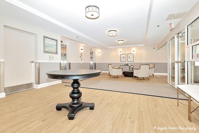 390 W Mahogany Ct Unit 301, Palatine, IL 60067 - interior space with wood finished floors, elevator, a tray ceiling, ornamental molding, and baseboards