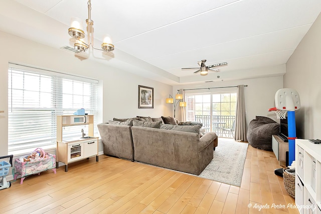 390 W Mahogany Ct Unit 301, Palatine, IL 60067 - living area featuring light wood-style flooring, a ceiling fan, and a chandelier