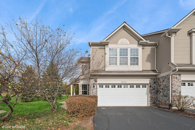 15130 Laurel Ln, Lockport, IL 60441 - traditional home featuring a garage, driveway, and stone siding