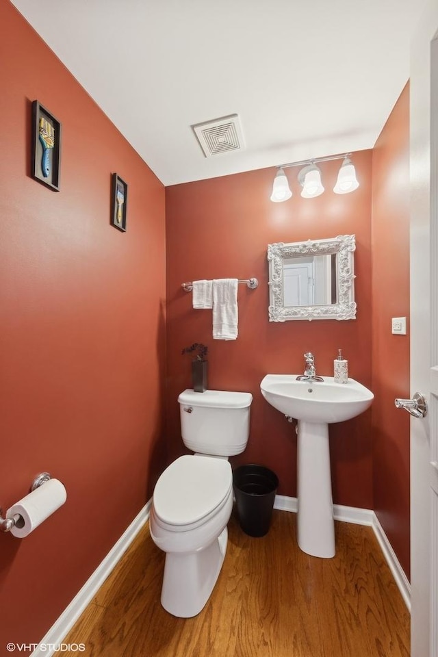 15130 Laurel Ln, Lockport, IL 60441 - bathroom with wood finished floors, toilet, baseboards, and a sink