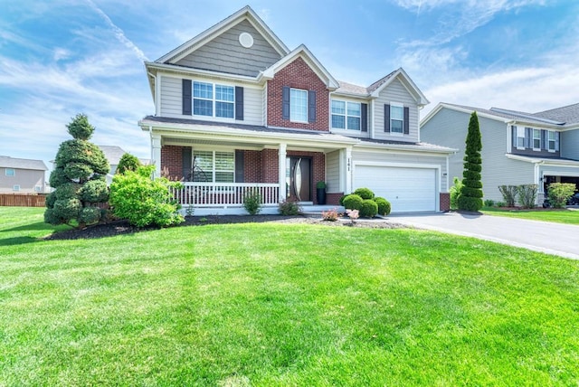 141 Bluegrass Pkwy, Oswego, IL 60543 - traditional-style house featuring brick siding, covered porch, driveway, a garage, and a front lawn