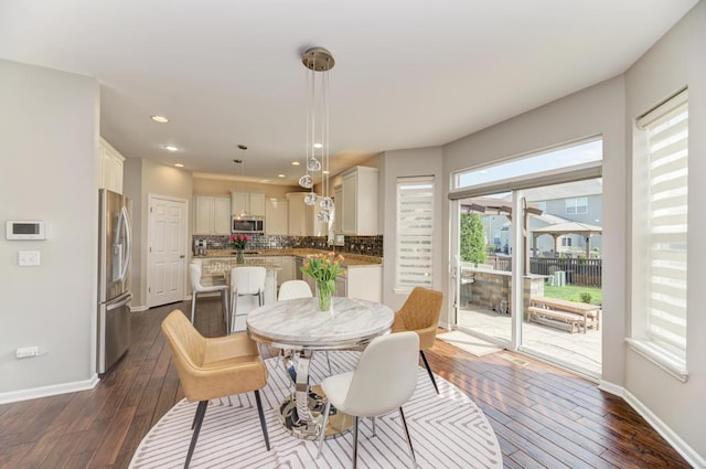 141 Bluegrass Pkwy, Oswego, IL 60543 - dining area featuring dark wood finished floors, baseboards, and recessed lighting