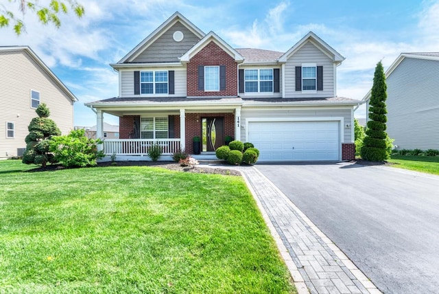 141 Bluegrass Pkwy, Oswego, IL 60543 - view of front facade with brick siding, driveway, a porch, a garage, and a front lawn